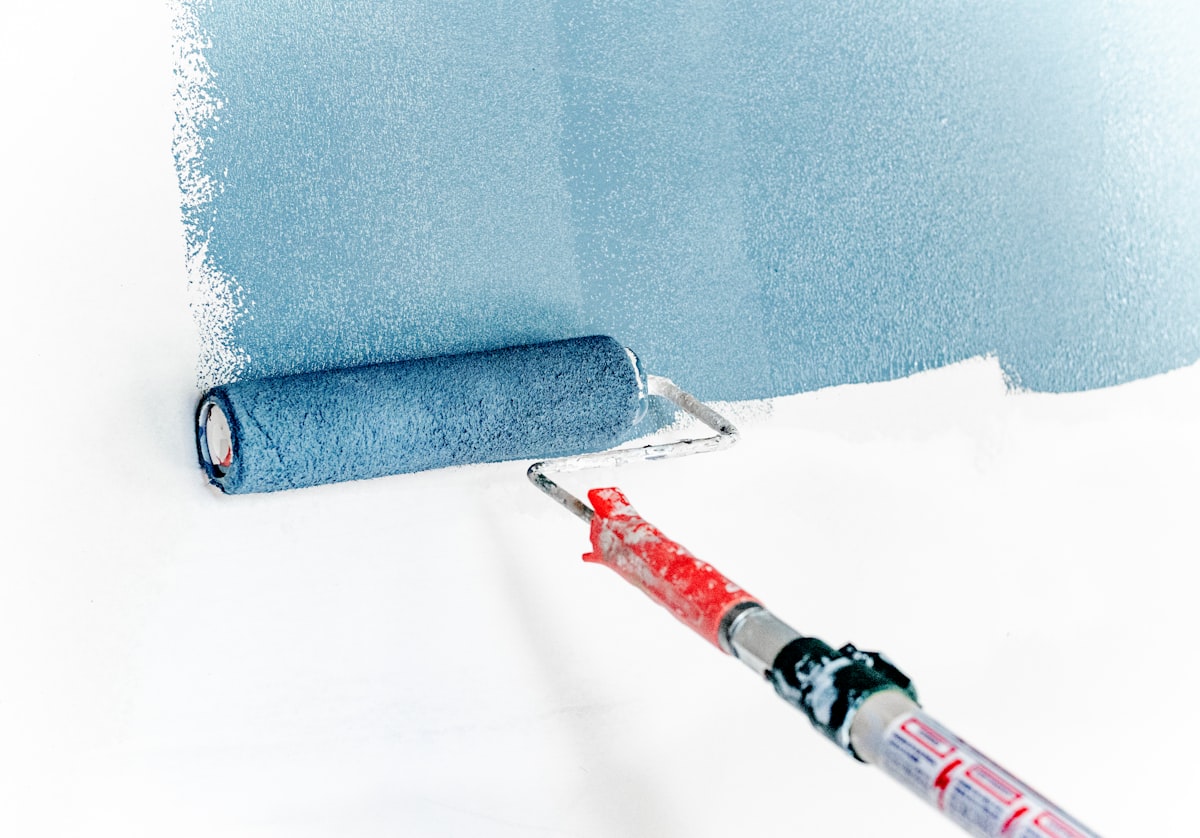 Painter applying paint with a roller